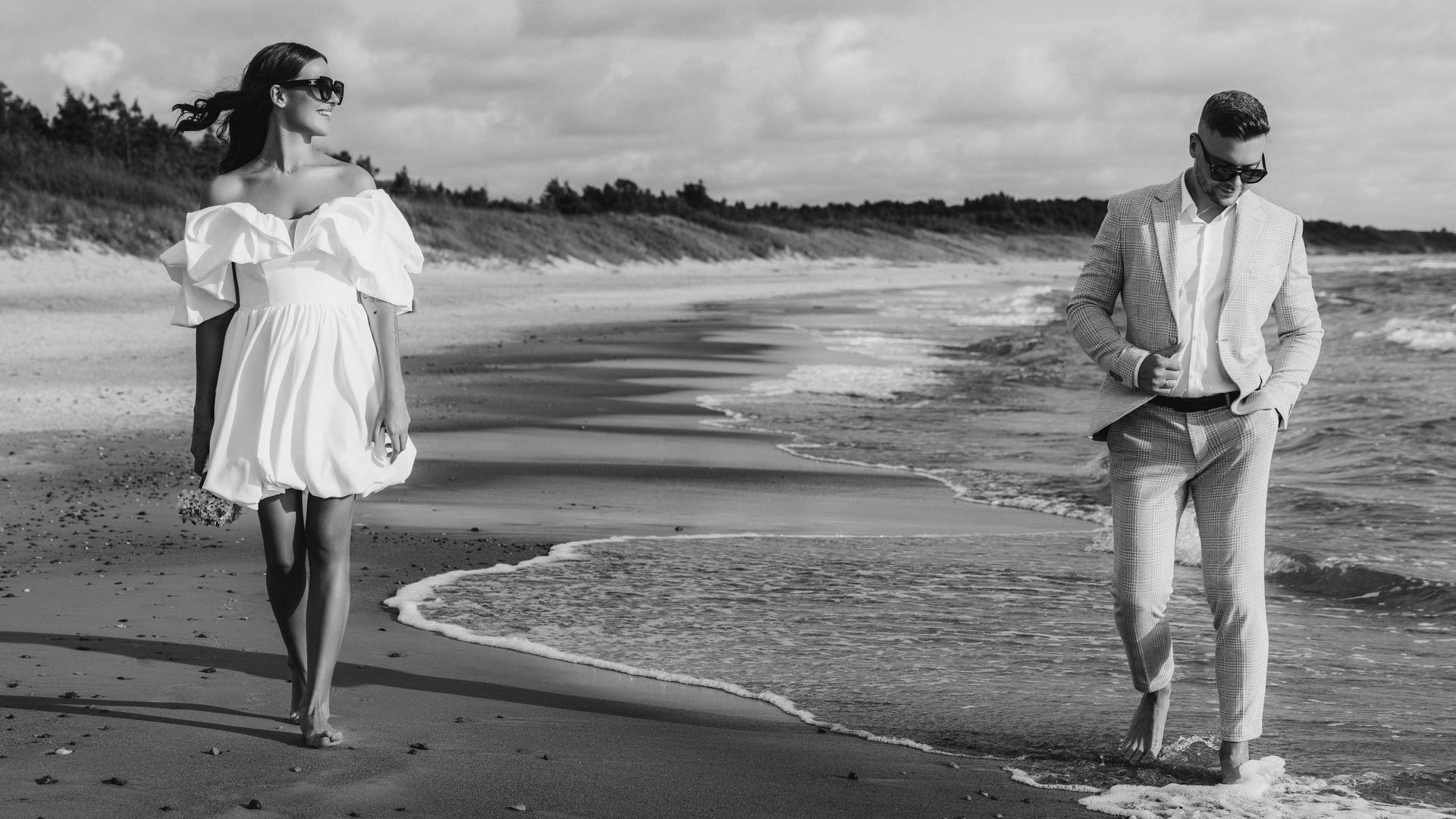 Wedding couple walking in the sandy see beach